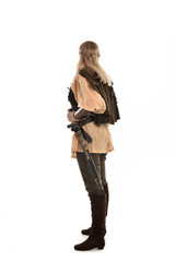 full length portrait of girl wearing medieval costume with sword. standing pose with back to the camera, isolated on white studio background.