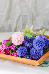 Bouquet of different colors hyacinth flowers on a wooden board. Flower shop concept.