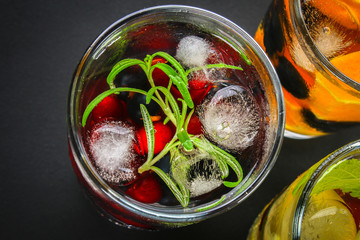 Various detox water in glasses, different tastes, berries, fruits.