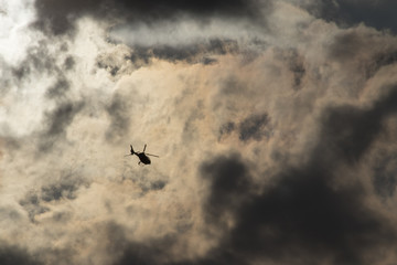 Helicopter, flying in cloudy evening light
