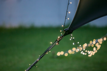 Bokeh Fairy Lights on a string hanging from an outdoor Bedouin tent