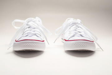 White sneakers on white background