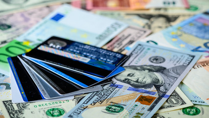 Dollar vs euro banknotes and credit cards as background. Concept