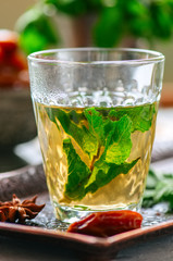 Traditional moroccan mint tea with dates on a vintage tray. White stone background. Close up.