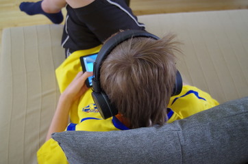 Young boy playing with his tablet