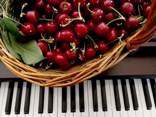 basket with cherries and piano keys