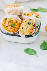 Savory potato spinach and feta muffins. White stone background.