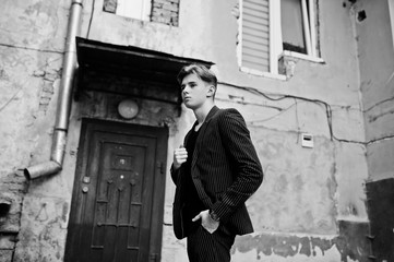 Fototapeta na wymiar Young stylish macho boy in black jacket posed outdoor of street. Amazing model man.