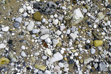 White grey black stones on the sand