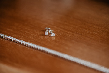 Detail of diamond earring and diamond tennis