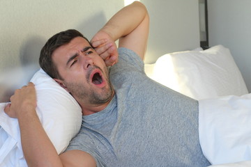 Fototapeta na wymiar Man feeling severe toothache in bed 