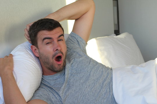 Lazy Man Yawning In Bed 