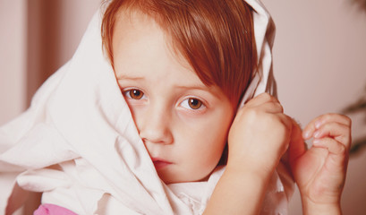 Little сute sad child girl is cold and has a high fever. (health, childhood, sadness concept)
