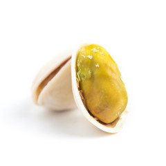few ripe roasted pistachios isolated on white background