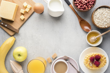 Healthy Breakfast Cheese Juice coffee Honey Peanuts Egg Biscuits Waffles Cereal Oatmeal Apple Banana. Selective focus. The view from the top. Flat position