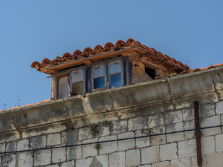 Vintage viewing place on top of the roof of old stone build traditional house.