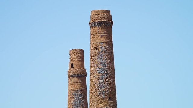 A zoomed in shot of tall ancient minarets in Herat.