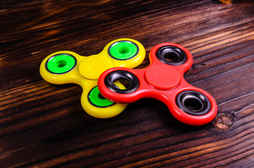 Two fidget spinners on wooden desk