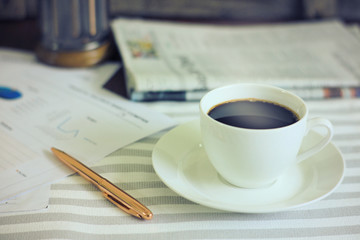 Coffee cup on working table in the morning