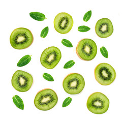 Fruit Pattern - Creative layout made of Kiwi fruits and mint leaf. Many slices of ripe  Kiwifruit..Flat lay.