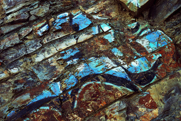 the texture of the rocks with bright graffiti