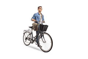 Fototapeta na wymiar Young man pushing a bicycle