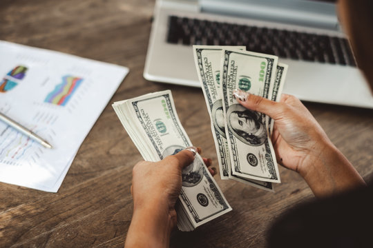 Woman accountant counting money dollars banknote, business financial concept