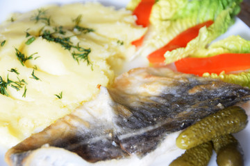 stewed potatoes with dill, lettuce, pickled cucumber and red pepper, fried fish cod,