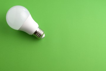 White lightbulb on a green background