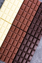 chocolate in diffrent color. milk, dark and white chocolate bars
