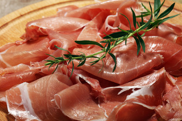 Italian prosciutto crudo or jamon with parsley. Raw ham