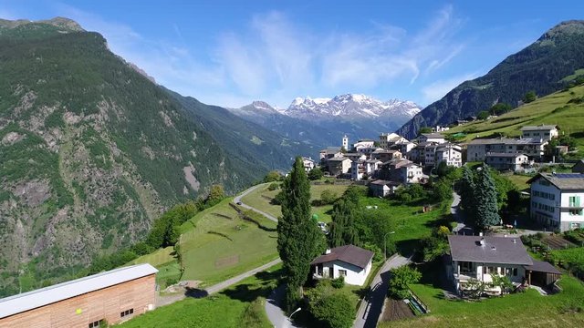 Village of Viano in Val Poschiavo. Aerial view. Green meadows and small village in Switzerland. 