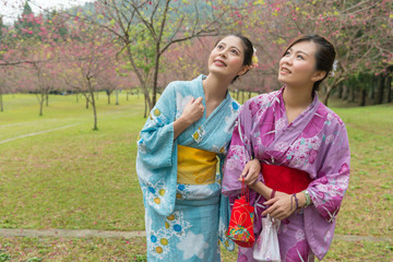 Fototapeta na wymiar Two young Asian girls stand walking together