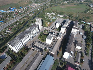 Top view of a silo elevator. The huge building for storing and drying grain. Aerophotographing industrial object.