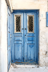 Fototapeta na wymiar Vintage blue wooden door with cracked paint