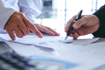 close up hands.business team meeting to discuss statistical data presented in the form of digital graphs and charts