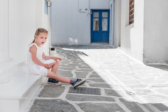 Little girl sitting on the porch, Greece