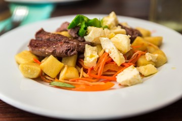 Tenderloin stripes, gnocchi, cheese and grilled grated vegetable.