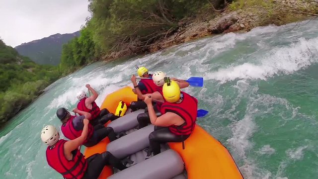 People in boat enjoy on whitewater rafting trip on Tara river in Montenegro, slow motion