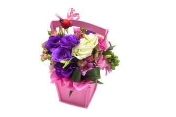 flower arrangement with roses, freesias in a pot on a white background
