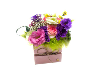 flower arrangement with roses, freesias in a pot on a white background
