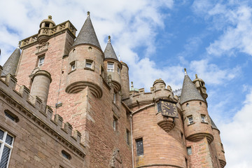 View of turrets and clock of Glamis Castle in Angus, Scotland.  Glamis Castle is situated close to the village of Glamis and is the home of the Earl of Strathmore and Kinghorne.
