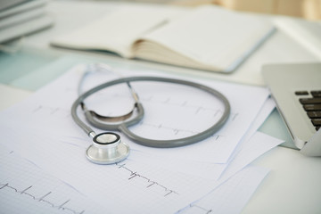 Close-up of stethoscope and cardiogram on the desk at doctor's office