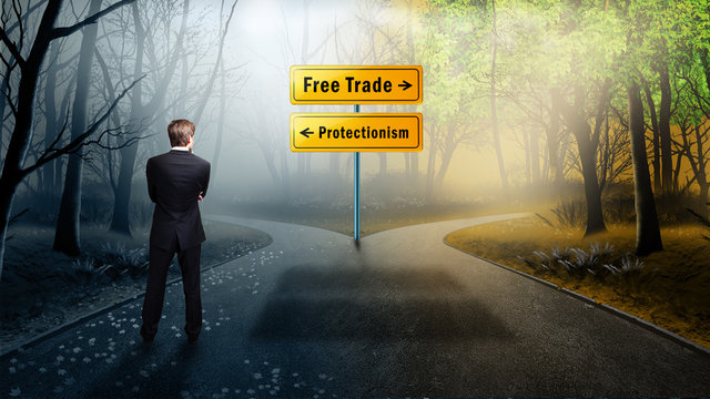Businessman stands on crossroad between "free trade" and "protectionism" 