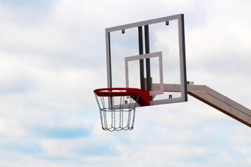 Basketball board on the sports field against the sky