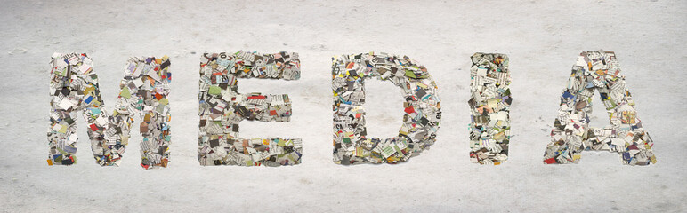 the word    MEDIA made from newspaper confetti isolated on old paper
