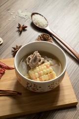 Bone soup with wood grain background