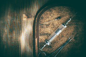 Naklejka premium Old medicine equipment on wooden background.