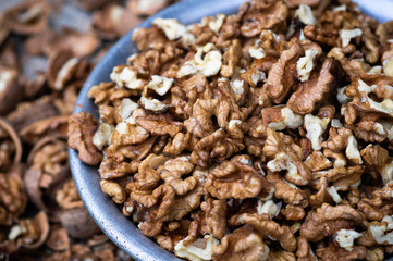 Walnuts kernels with color background, Whole walnut in a metal plate. Walnuts. Walnuts an market. Background of walnuts. Healthy.