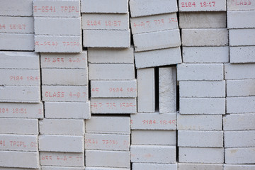 A group of lightweight concrete for construction. Gray white brick with red alphabet written on.